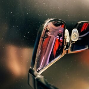 Artistic close-up shot of sunglasses with a reflective surface.