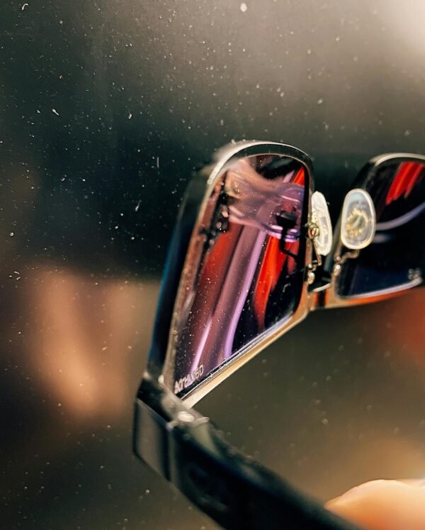 Artistic close-up shot of sunglasses with a reflective surface.